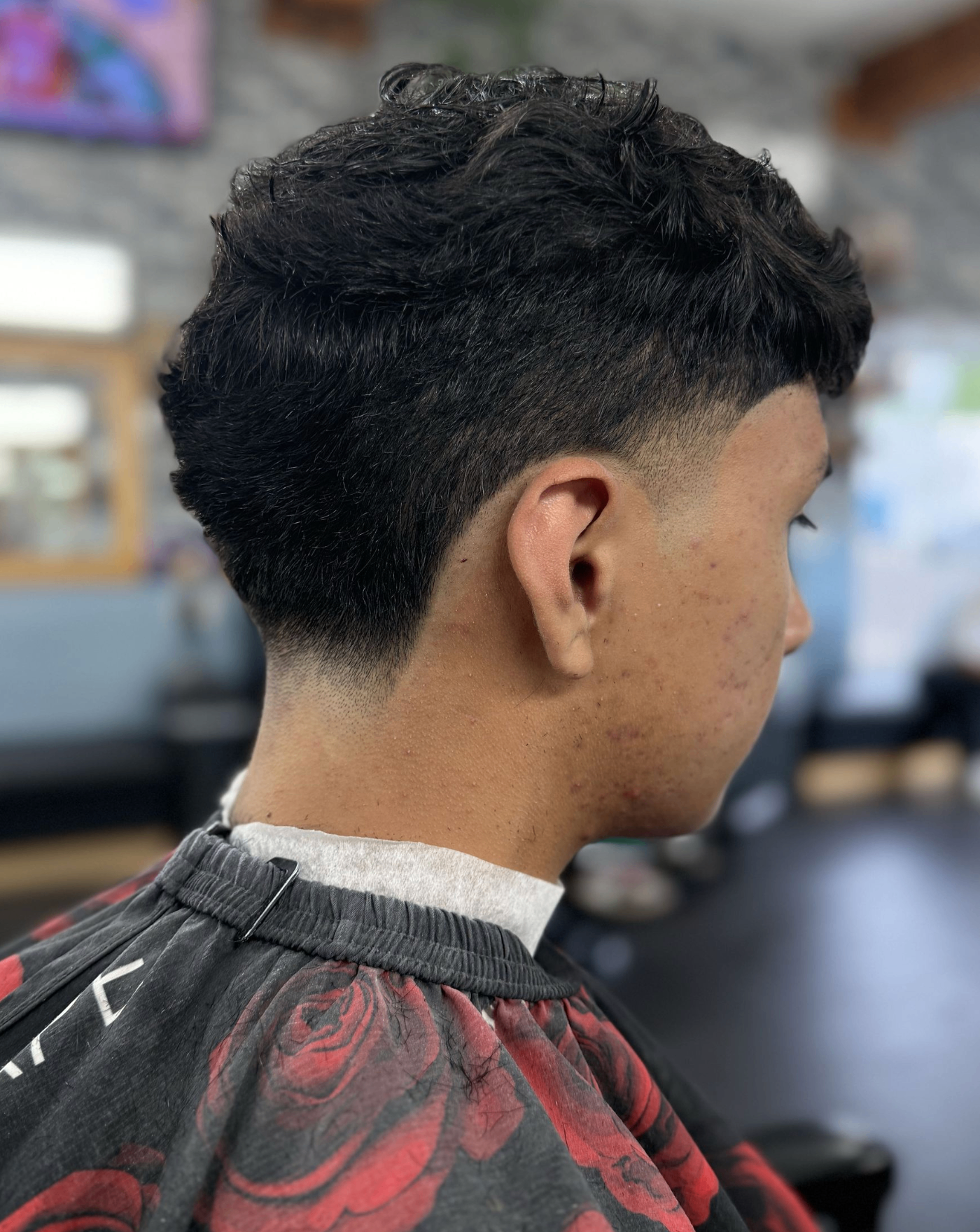 Curly textured haircut with taper fade